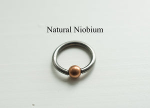 PIERCING RING WITH COPPER OR BRASS BALL